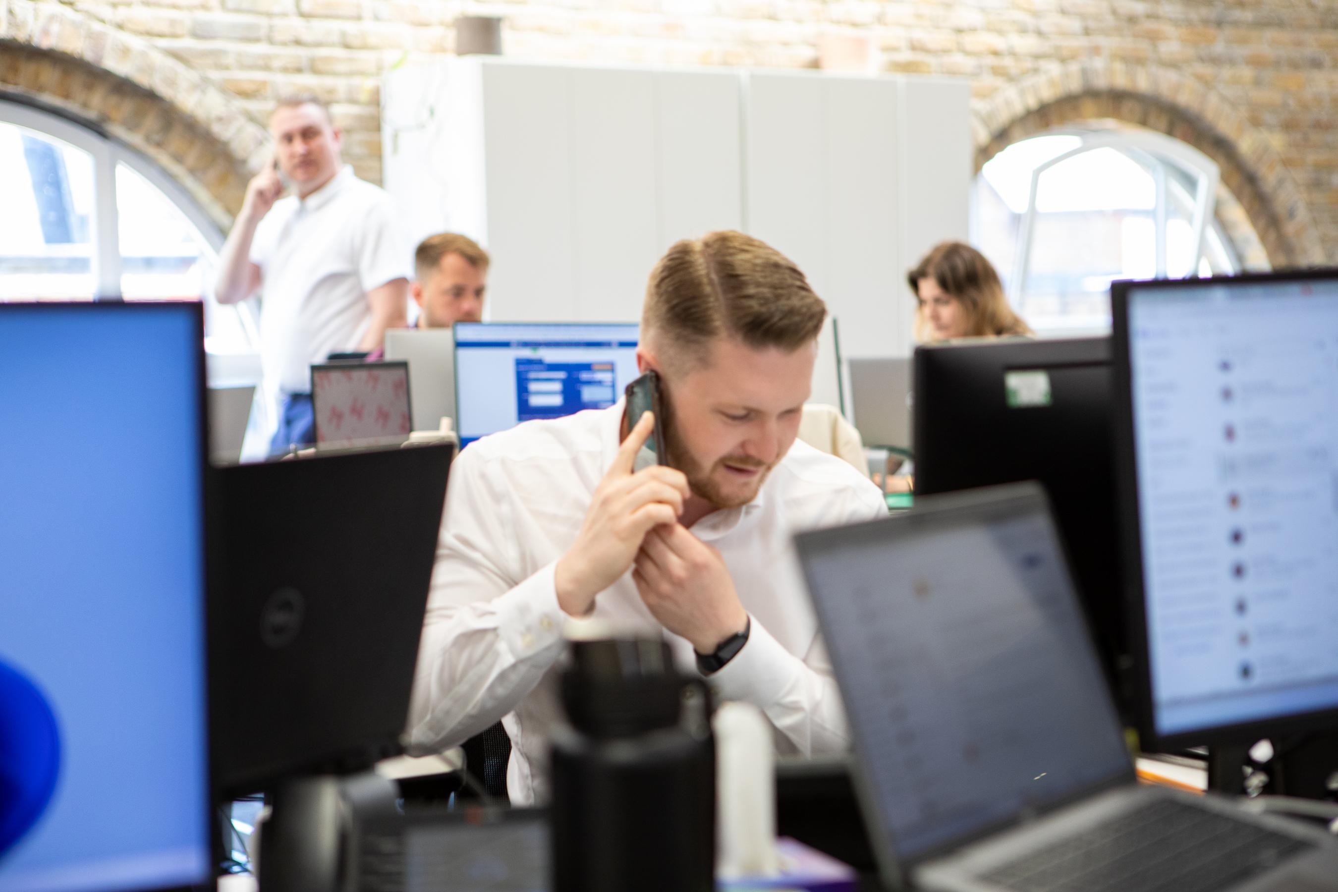 man taking a phone call in an office environment